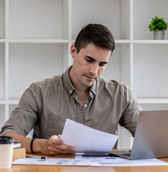 Tax Purpose agent in Ringwood reviewing financial paperwork at desk, providing accurate tax return, BAS, and compliance services for individuals and businesses.